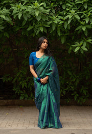 Close-up of peacock tissue silk saree pallu with coin embossed border