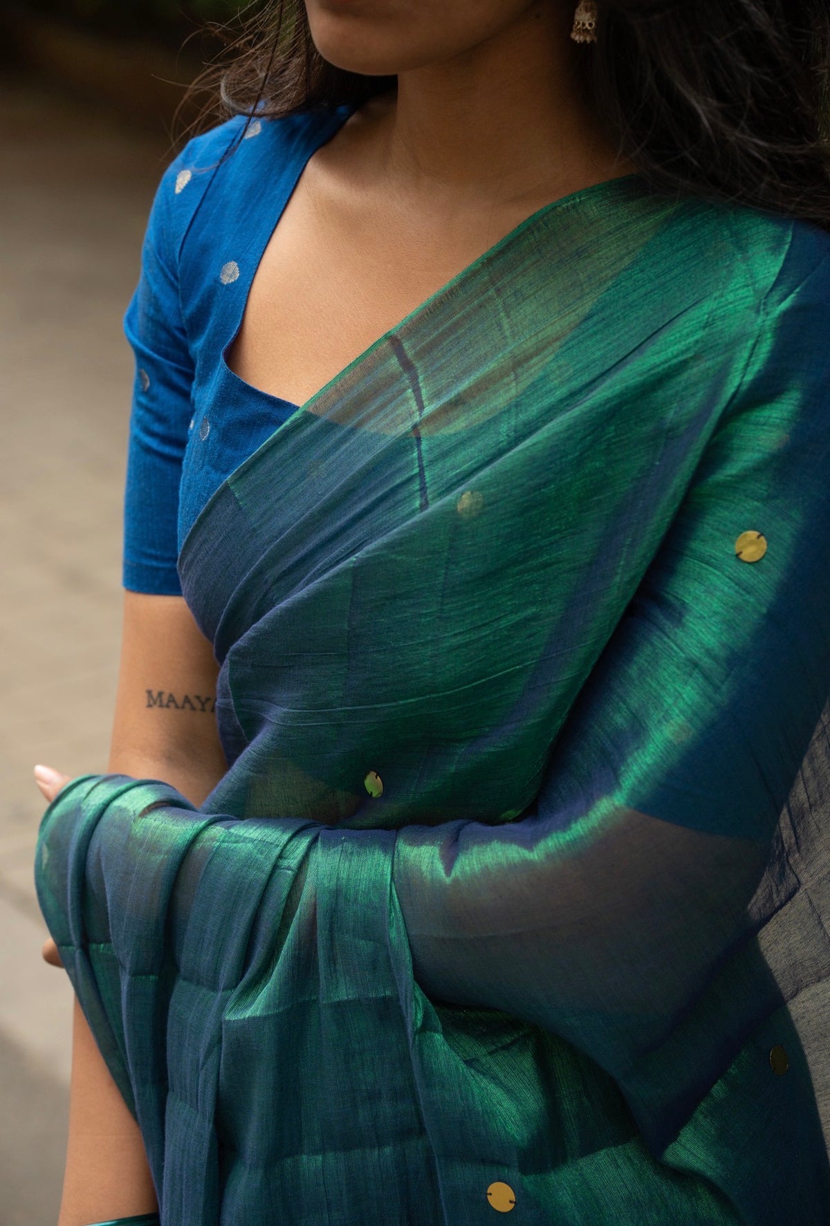 Peacock tissue silk saree pleats and tassel detail