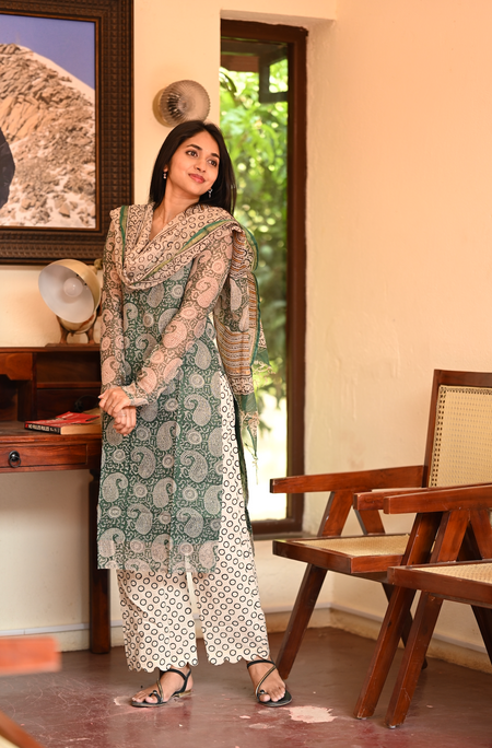 Woman wearing green paisley print Kota cotton kurti set with matching dupatta, close-up portrait.