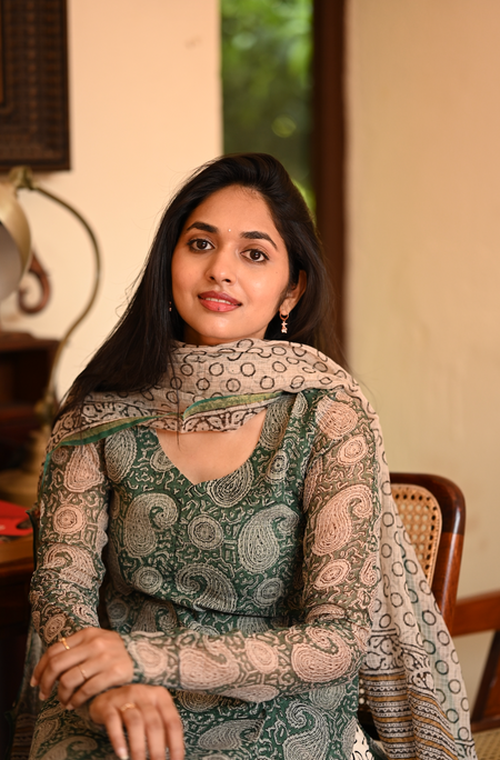 Woman wearing green paisley print Kota cotton kurti set with matching dupatta, close-up portrait