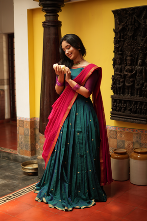 Maragadham Narayanpet fusion half saree in green and red, featuring a handloom pleated skirt, matching blouse, and elegant traditional drape.