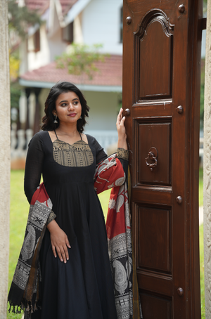 Black Anarkali dress online featuring a Kalamkari yoke design, temple border accents, and artisanal handloom-inspired details.