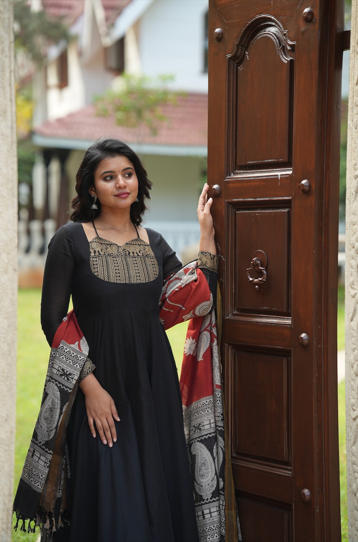 Black Anarkali dress online featuring a Kalamkari yoke design, temple border accents, and artisanal handloom-inspired details.