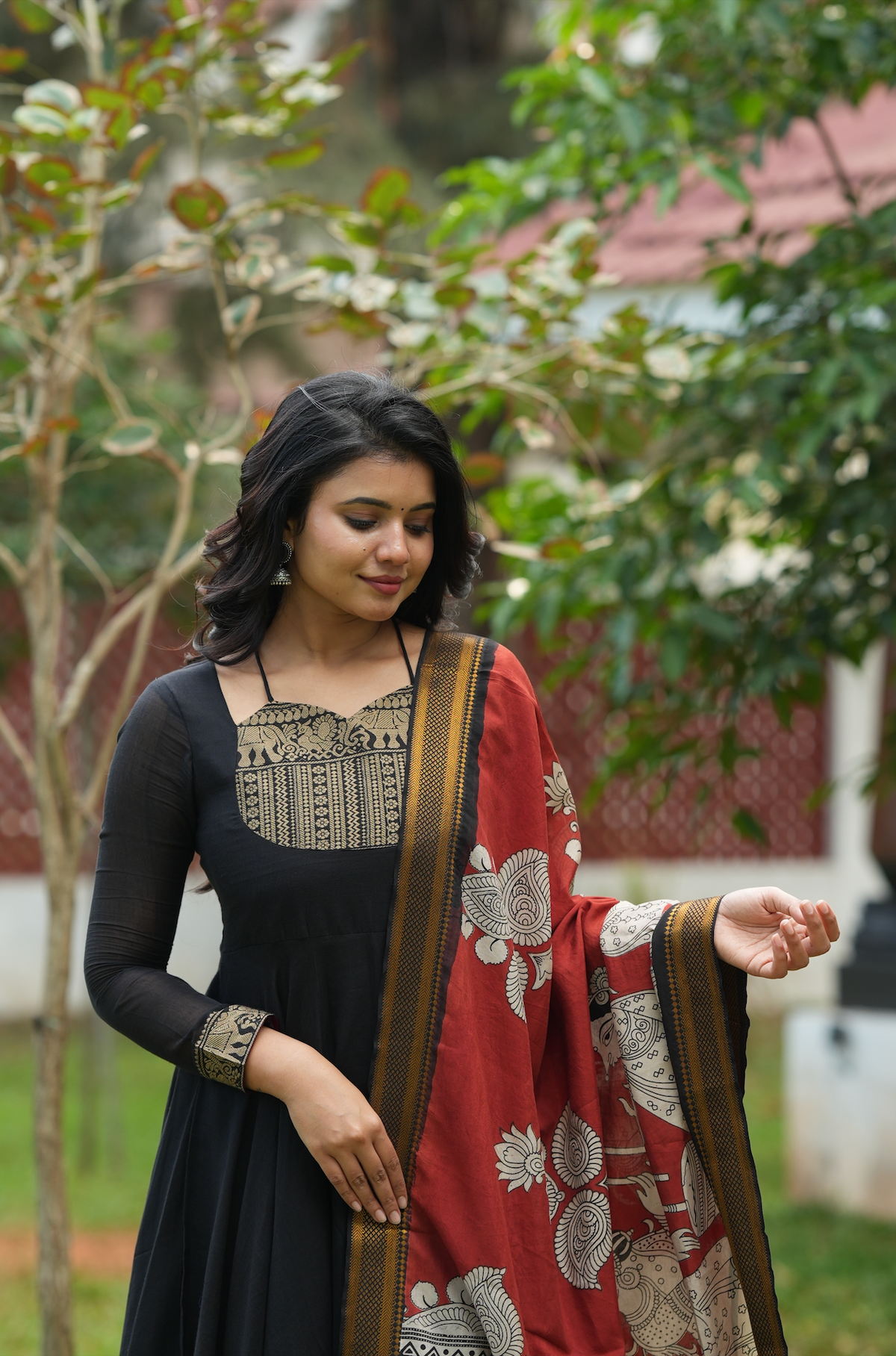 Black Anarkali dress online featuring a Kalamkari yoke design, temple border accents, and artisanal handloom-inspired details.