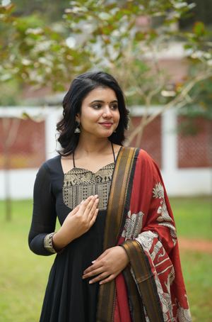 Elegant black Anarkali suit online with handcrafted Kalamkari dupatta and ethnic festive styling.