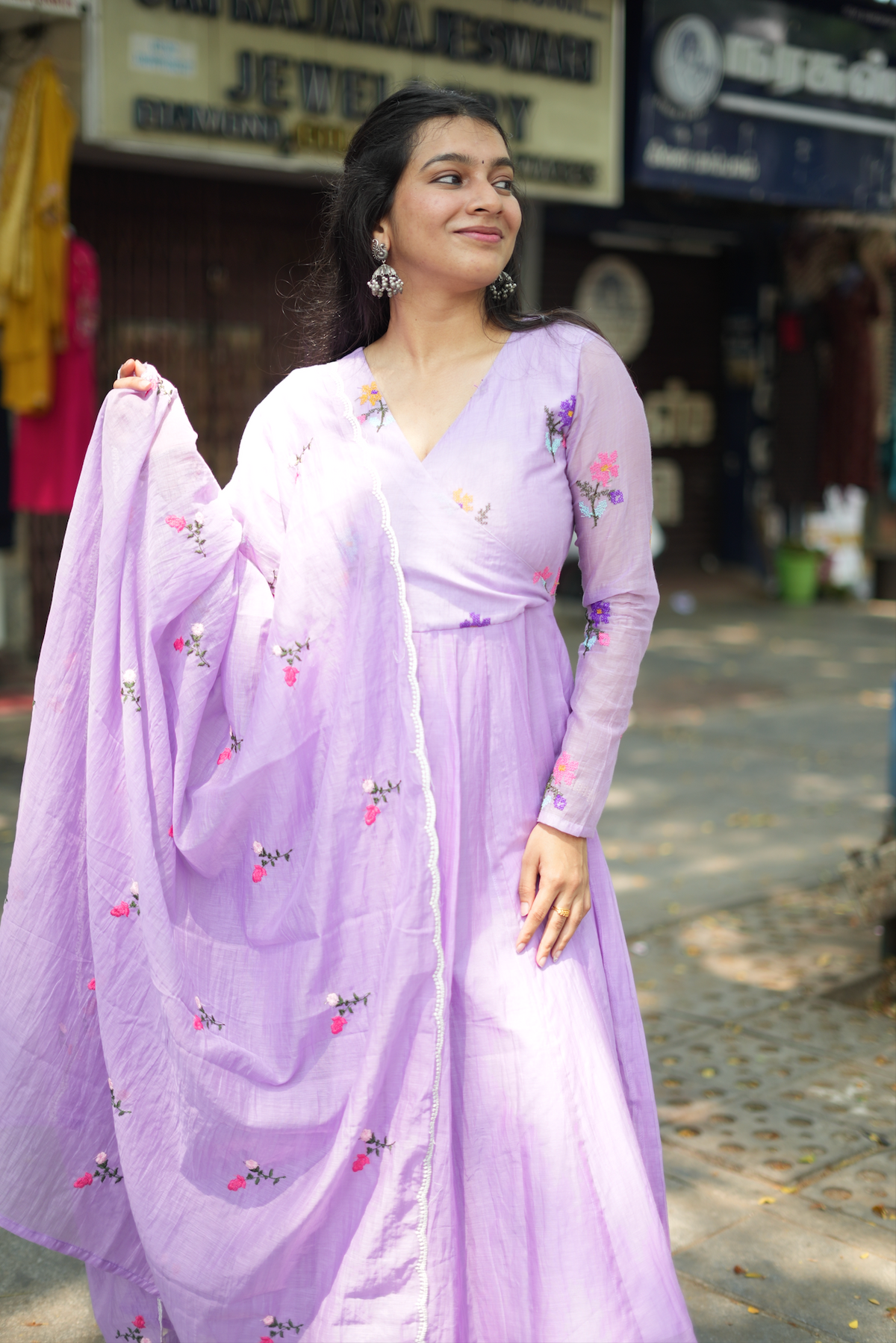 Violet embroidered Anarkali suit with flowing dupatta, featuring delicate floral embroidery and elegant ethnic styling.