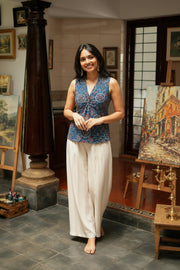 Indigo blue floral crop top for women featuring a sleeveless V-neck design, crafted from soft cotton fabric and paired with wide-leg trousers.