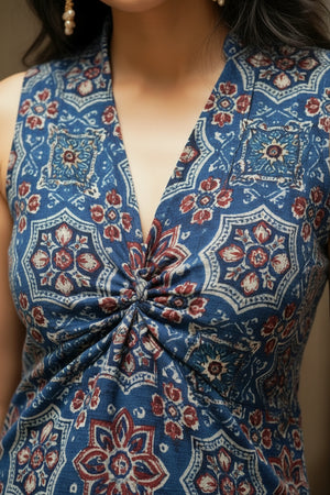 Close-up of the indigo blue floral crop top showcasing intricate floral motifs, twist front detailing, and a stylish V-neck design.