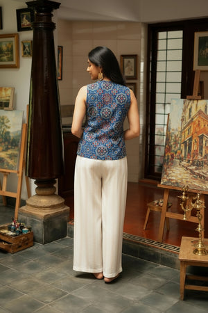 Back view of the indigo blue cotton crop top featuring a sleeveless fit, floral print, and comfortable everyday wear design.