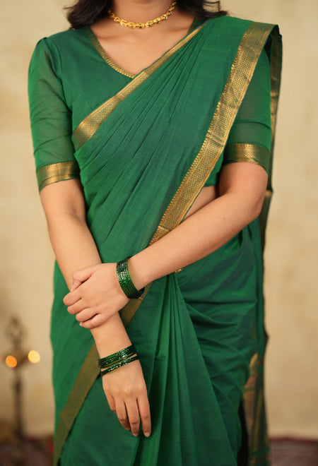 Handloom green cotton blouse paired with traditional saree and wide neckline ethnic styling