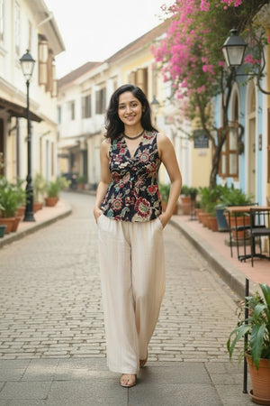 Designer floral V-neck crop top with twist front detail, styled with cream wide-leg pants for a modern summer outfit.