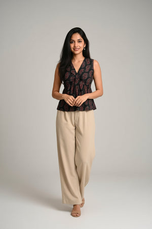 Black paisley sleeveless crop top paired with wide-leg trousers, creating a chic and versatile everyday outfit.