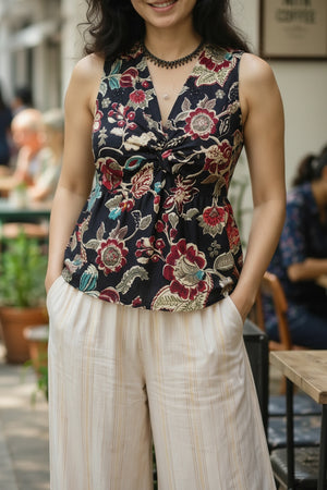 Close-up of floral twist front crop top showcasing the elegant knot detail, botanical print, and flattering V-neck silhouette.