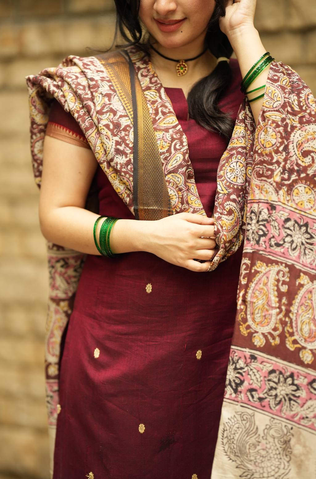 Close-up of maroon Narayanpet handloom kurta detailing with elegant printed Kalamkari dupatta border
