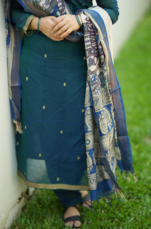 Close-up of peacock blue Narayanpet handloom fabric with elegant ethnic detailing and woven texture
