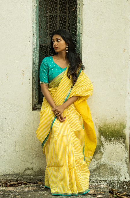 Full length view of woman in pure silk handwoven Maheshwari saree with gingham checks pattern — festive wear