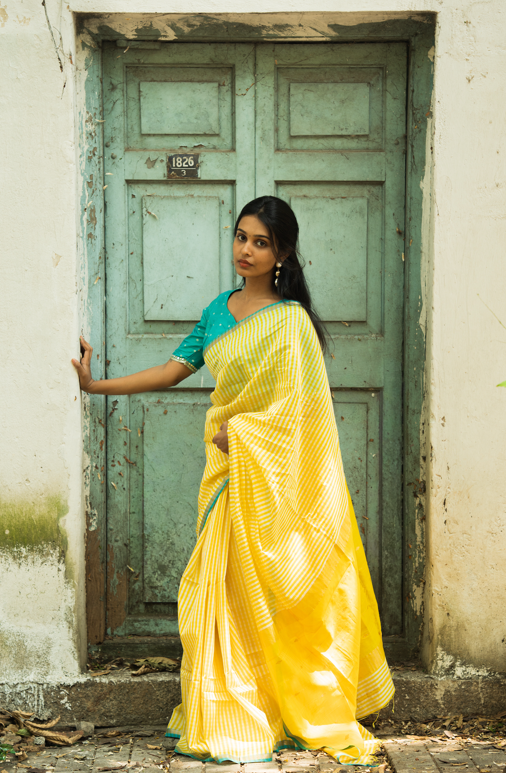 Woman wearing yellow Sundari gingham checks Maheshwari silk saree with teal contrast blouse — Vintage Closet