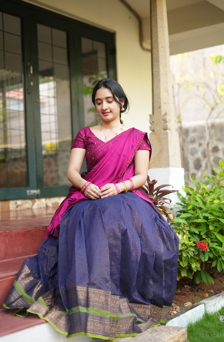 Traditional Chettinad half saree set with navy border skirt and plum georgette drape