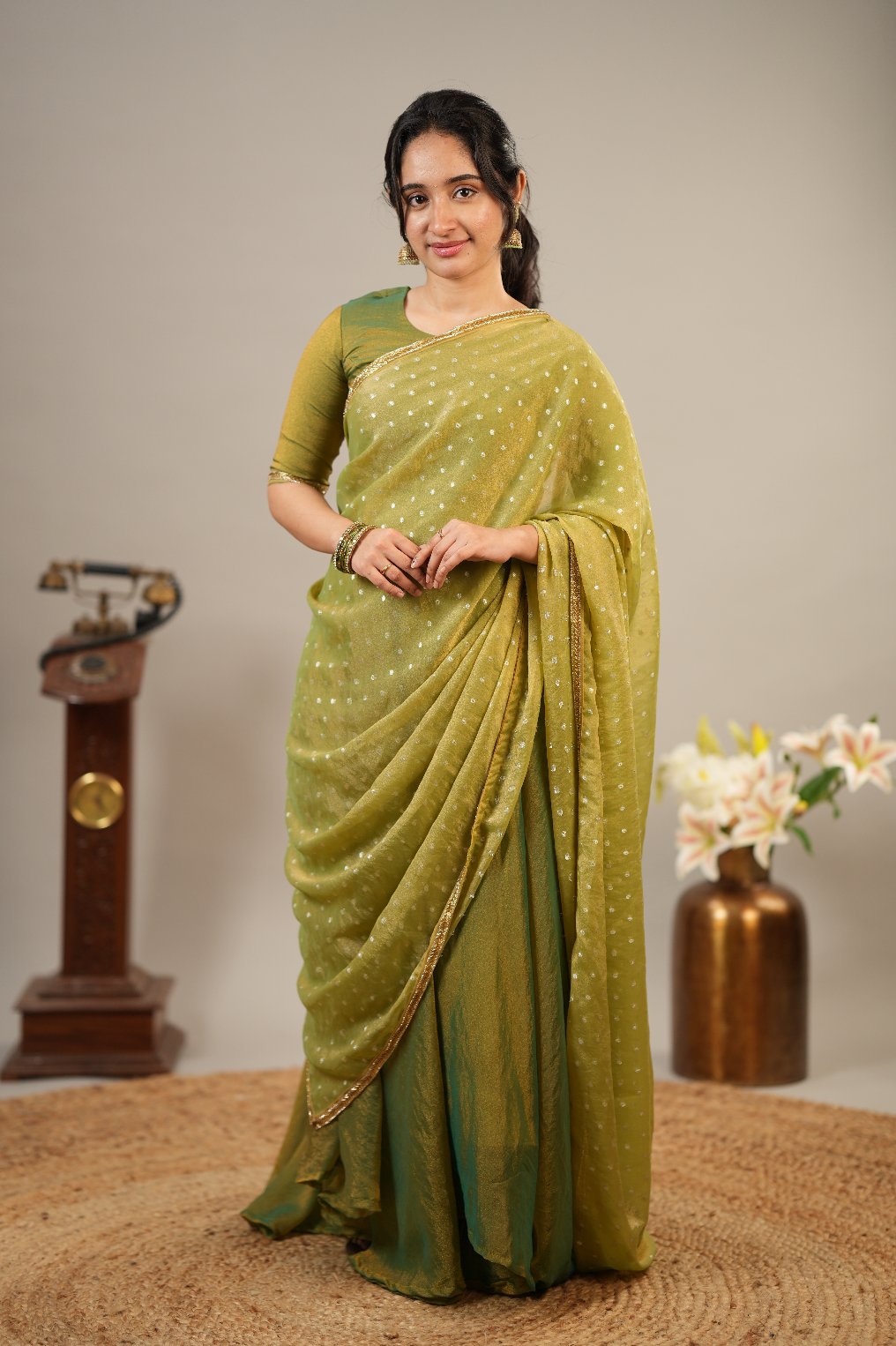 Traditional Indian festive sharara set in tissue silk fabric with embroidered dupatta border and elegant drape